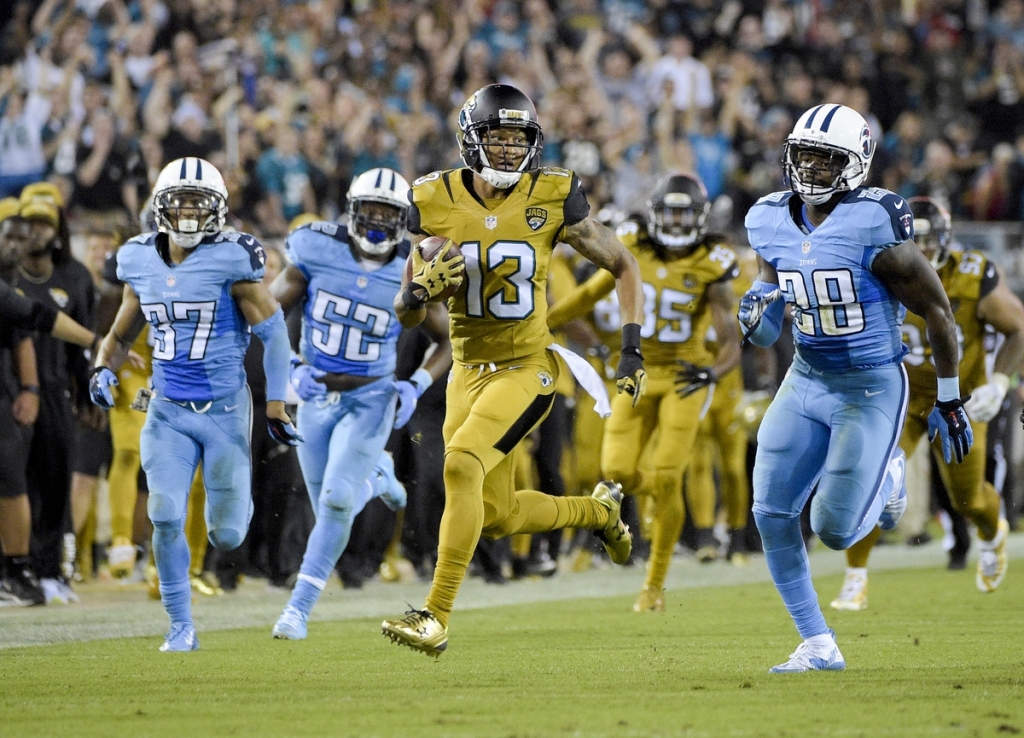 The Jaguars Rashad Greene runs back a punt return past Tennessee's Cody Riggs, Steven Johnson and Marqueston Huff during the second half of Thursday's game in Jacksonville Fla. The Jaguars won 19-13