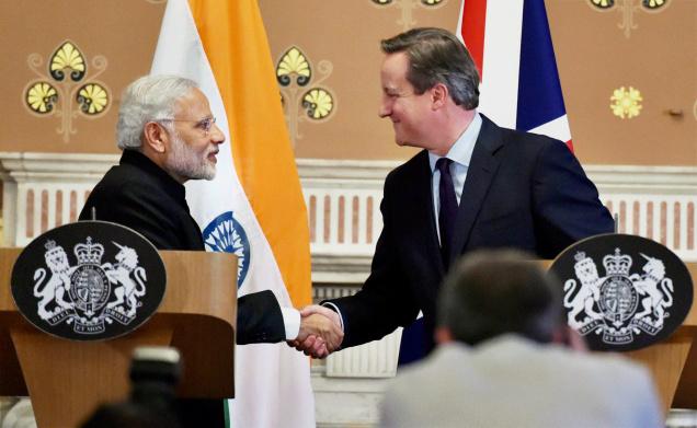 Prime Minister Narendra Modi and UK PM David Cameron shake hands after the joint press conference in London