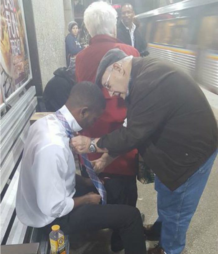 Heartwarming photo of couple teaching young man to tie his tie goes viral