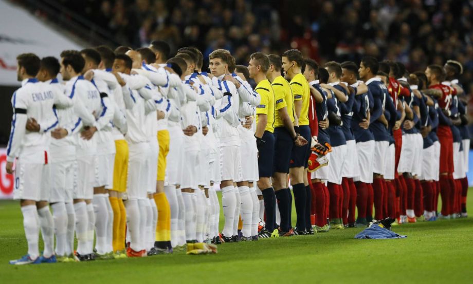 England and French players line up ahead of the international friendly soccer match between England and France at Wembley Stadium in London Tuesday Nov. 17 2015. France is playing England at Wembley on Tuesday after the countries decided the match shou