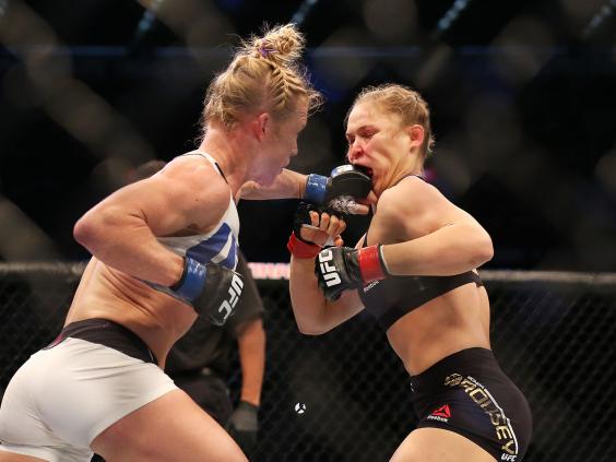 Holly Holm lands a blow on Ronda Rousey