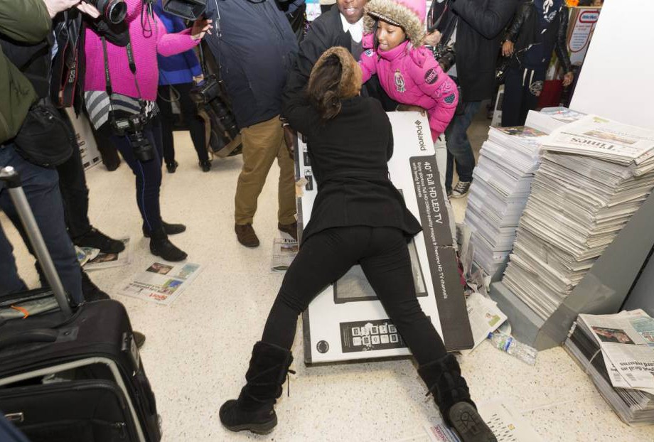 REX Customers fighting over discounted large television sets Black Friday Sales at Asda Wembley Superstore London Britain 28 Nov 2014