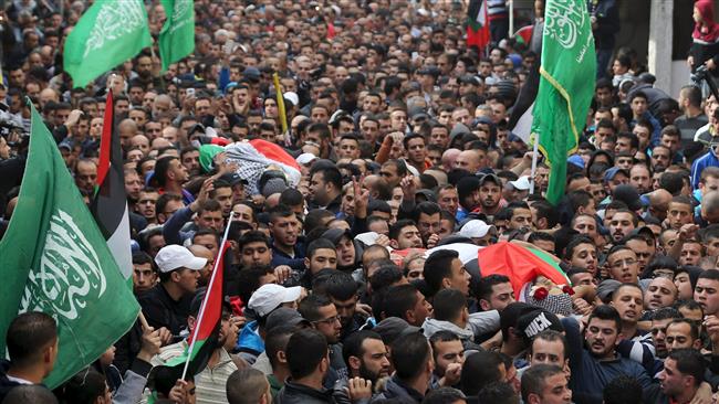 Mourners carry the bodies of two Palestinians killed by Israeli troops during their funeral in Qalandiya refugee camp near the occupied West Bank city of Ramallah