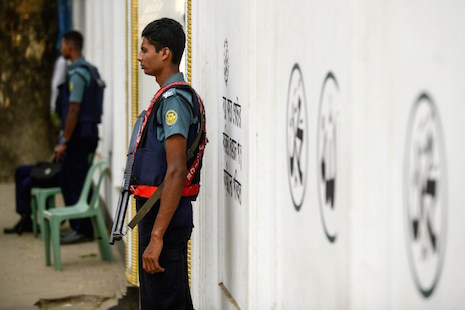 Bangladeshi police personnel stand guard in front of a Shia mosque in Dhaka on Nov. 27 a day after one man was killed when gunmen opened fire at a Shia mosque in northern Bangladesh