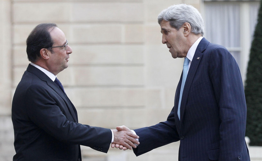 French President François Hollande welcomes U.S. Secretary of State John Kerry prior to a meeting at the Élysée Presidential Palace