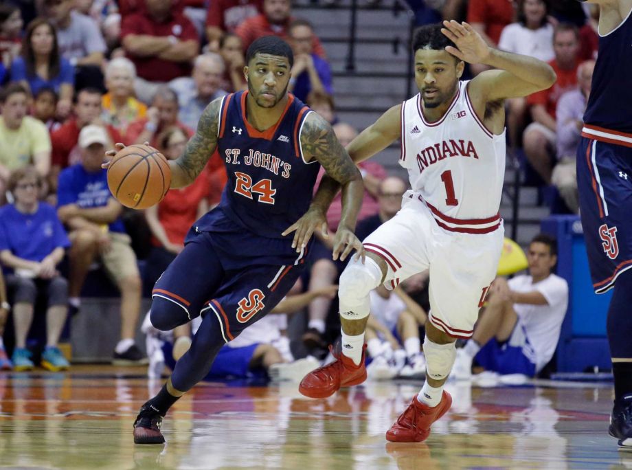 St. John's forward Ron Mvouika brings the ball up court as Indiana guard James Blackmon Jr. defends in the first half during an NCAA college basketball game in the second round of the Maui Invitational Tuesday Nov. 24 2015 in Lahaina Hawaii