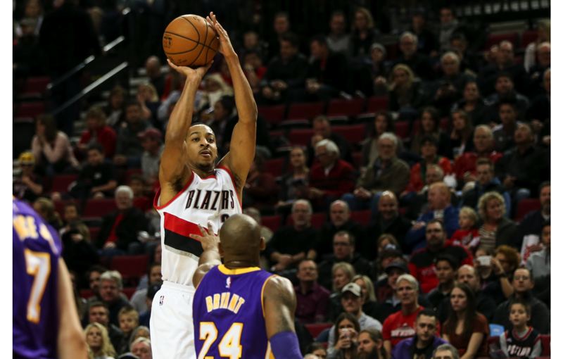 Blazers guard CJ Mc Collum launches a jump shot over Kobe Bryant of the Los Angeles Lakers