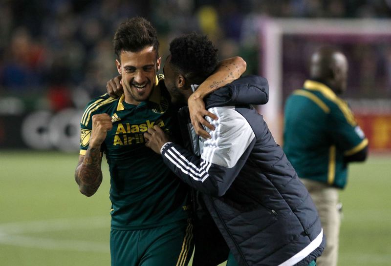 Maximiliano Urruti and Rodney Wallace celebrate the Portland Timbers playoff win over Sporting Kansas City