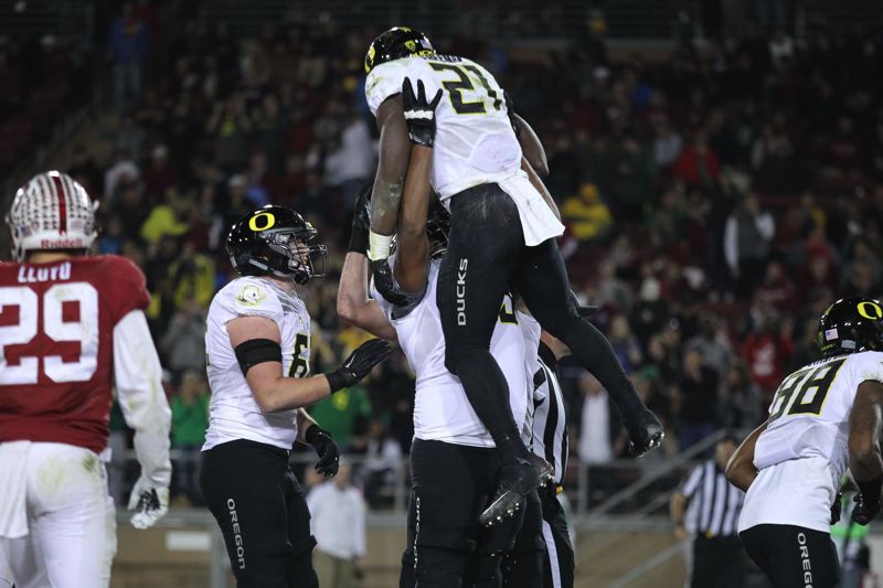 Oregon running back Royce Freeman gets a lift after scoring against Stanford last week