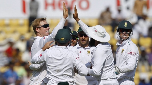 South Africa's Simon Harmer celebrates with his teammates after taking the wicket of India's Rohit Sharma on the first day of the third test