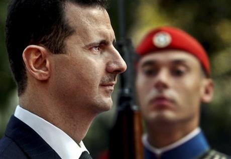 Syrian President Bashar Assad reviews the presidential guard during a welcoming ceremony in Athens. The tide of global rage against the Islamic State group lends greater urgency to ending the jihadis’ ability to operate at will from a base in war-torn S