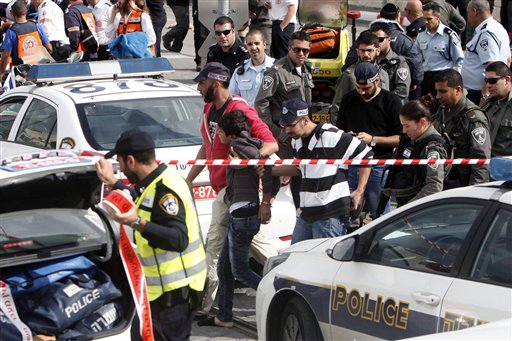 Israeli police officers arrest a Palestinian boy suspected in a stabbing attack in a light rail train in Jerusalem Tuesday Nov. 10 2015. Israeli police say Palestinian assailants have attempted to carry out a pair of stabbing attacks on Israelis in Jer