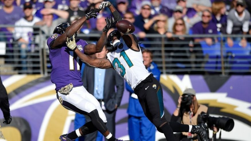 Jacksonville Jaguars cornerback Davon House right breaks up a pass-attempt to Baltimore Ravens wide receiver Kamar Aiken in the first half an NFL football game Sunday Nov. 15 2015 in Baltimore