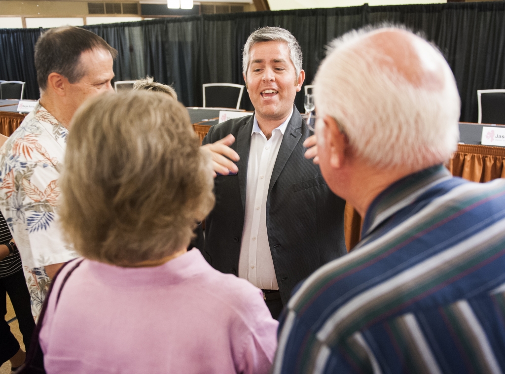 Jimmy Flannigan center is shown talking to voters after a September 2014 forum at Hope Presbyterian Church