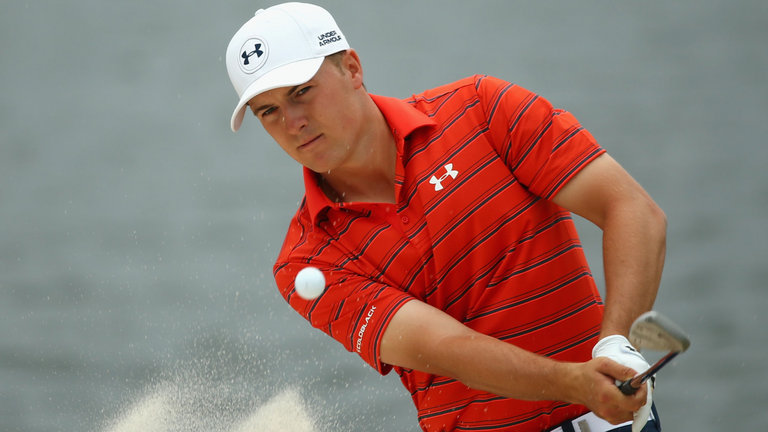 Jordan Spieth splashes out of a bunker at the fourth hole on day three in Sydney