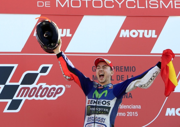 Jorge Lorenzo celebrates on the podium after winning the MotoGP World title at Valencia