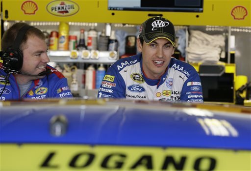 Joey Logano chats in the garage before the start of NSACAR Sprint Cup auto race practice at Texas Motor Speedway Friday Nov. 6 2015 in Fort Worth Texas. Logano's championship hopes took a significant blow when he was intentionally wrecked by Matt Ken