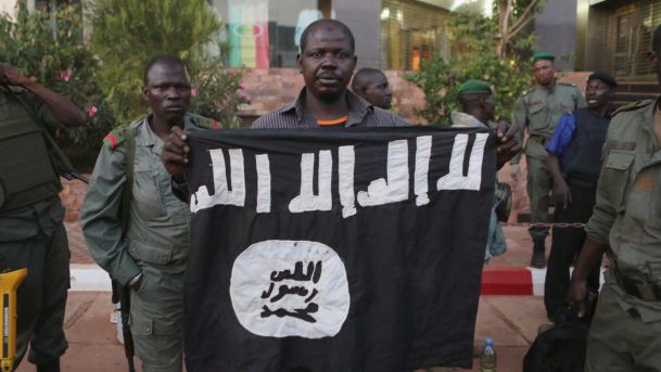 Malian security officials show a jihadist flag they said belonged to attackers in front of the Radisson hotel in Bamako Mali