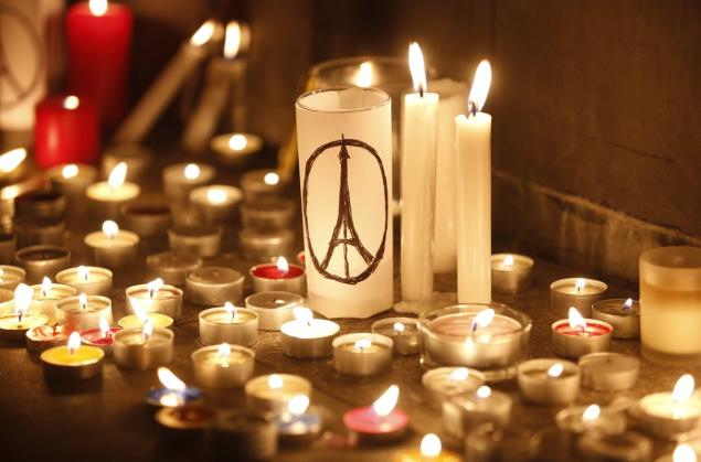 Candles are lit as people gather in Hong Kong Saturday to mourn for the victims killed in Friday's attacks in Paris