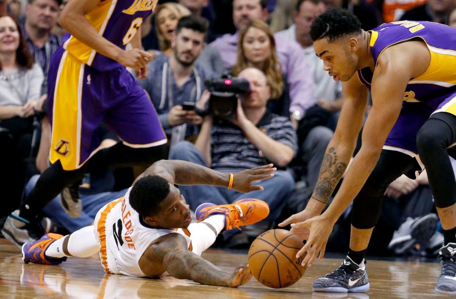 Los Angeles Lakers D'Angelo Russell right takes the ball away from Phoenix Suns Eric Bledsoe left during the first half of an NBA basketball game Monday Nov. 16 2015 in Phoenix