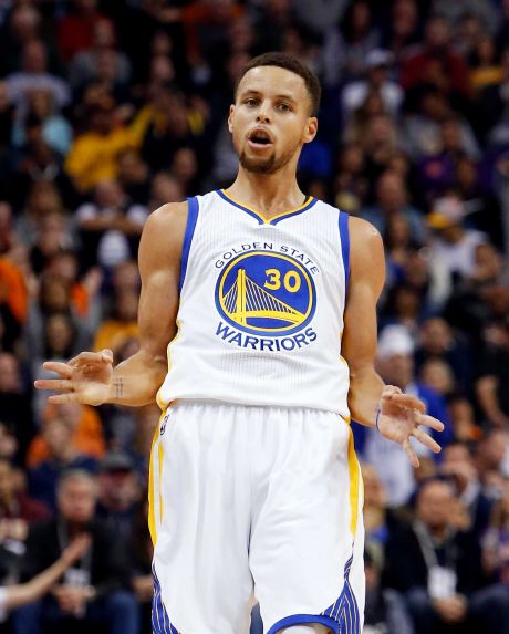 Golden State Warriors guard Stephen Curry reacts after scoring a three-point basket in the first quarter during an NBA basketball game against the Phoenix Suns Friday Nov. 27 2015 in Phoenix