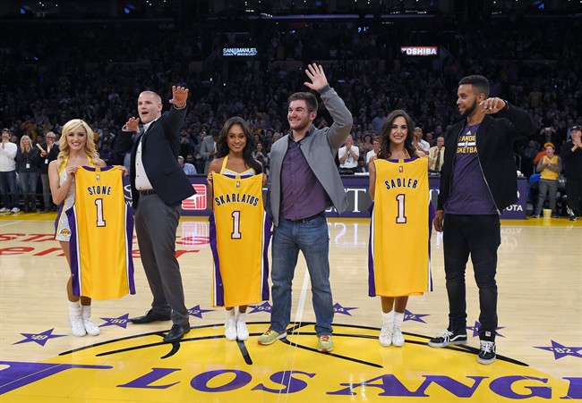 Spencer Stone left Alek Skarlatos center and Anthony Sadler wave to fans on court as they stand with Laker Girls during the first half of an NBA basketball game between the Los Angeles Lakers and the Detroit Pistons Sunday Nov. 15 2015 in Los Ange