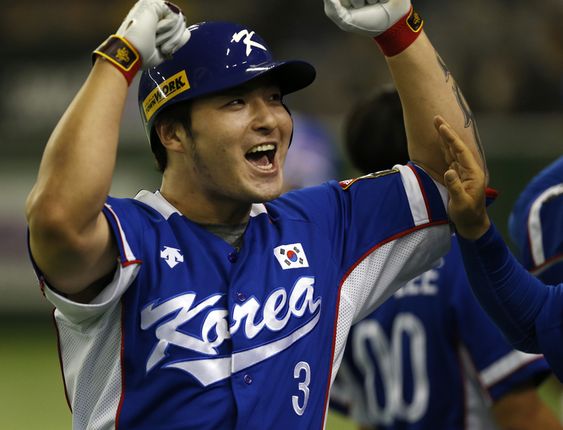 Byung-ho celebrates at the bench after hitting a three-run home run against Team USA in the fourth inning of their final game at the Premier12 world baseball tournament at Tokyo Dome in Tokyo Saturday Nov. 21 2015. (AP