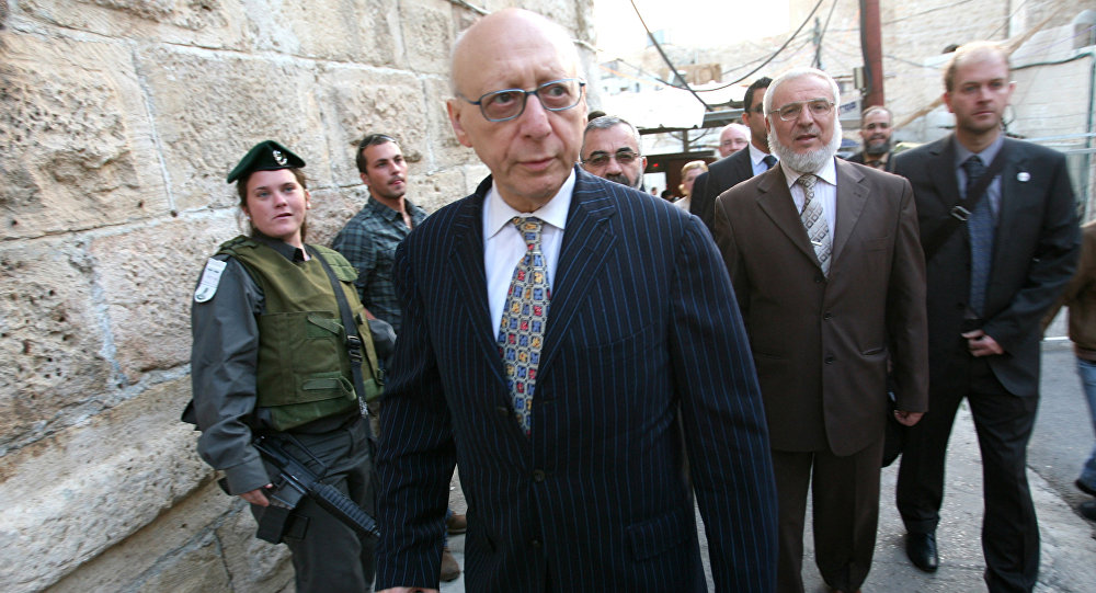 Hamas member Aziz Dweik, of the Palestinian Legislative Council walks with Jewish British MP Gerald Kaufman as they walk past Israeli border police guards standing at the entrance of the Abraham Mosque or the Tomb of the Patriarch a holy