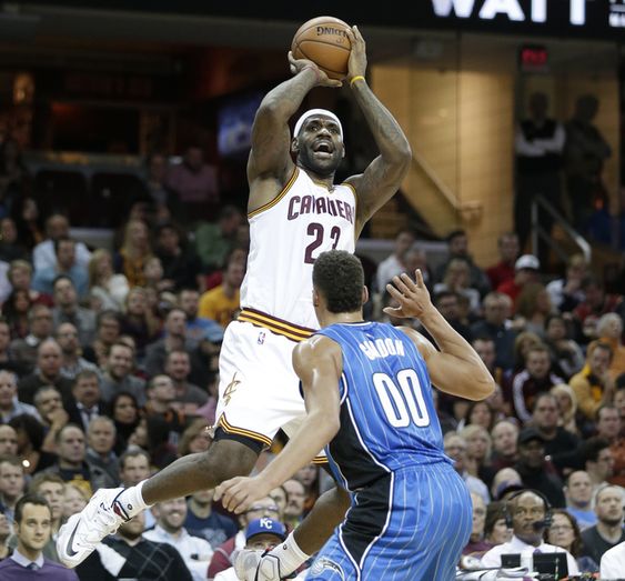 Bron James shoots over Orlando Magic's Aaron Gordon in the first half of an NBA basketball game Monday Nov. 23 2015 in Cleveland