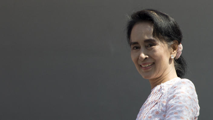 Leader of Myanmar's National League for Democracy party Aung San Suu Kyi smiles to her supporters after delivering a speech