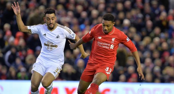 Liverpool's Jordon Ibe and Swansea City's Neil Taylor battle for the ball during the Premier League match at Anfield