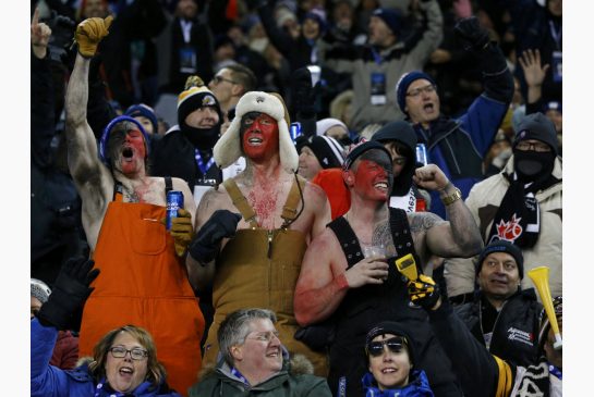 Ottawa Redblacks fans celebrate in the stands during Sunday's Grey Cup in chilly Winnipeg