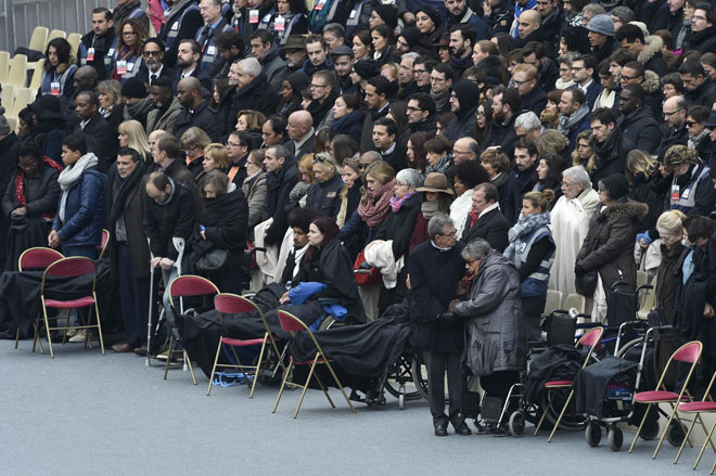 People wounded in the Paris terror attacks attend the ‘national and republican’ tribute a solemn ceremony in honour of the 130 people killed in the Nov 13 Paris attacks at the ‘Hotel des Invalides’. — AFP