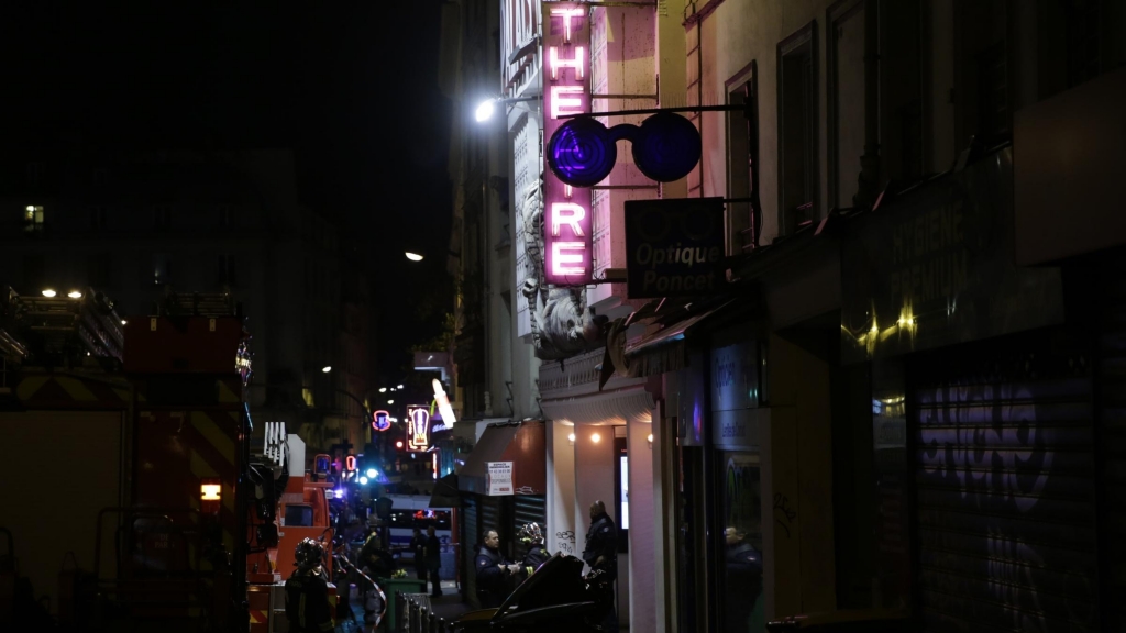 Police and rescuers survey the area around the Bataclan Theater after a coordinated attack in Paris on November 13