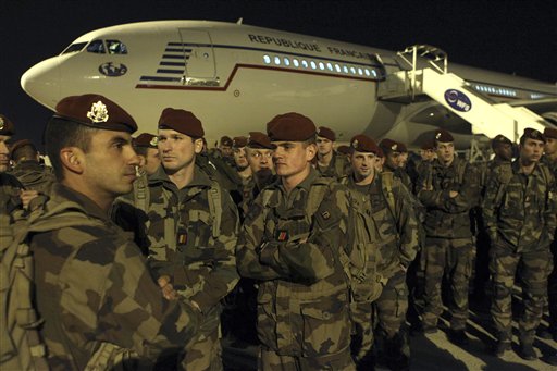 Soldiers stand on the tarmac of the Charles de Gaulle airport north of Paris as part of a security reinforcements Saturday Nov.14 2015. French President Francois Hollande said France would wage merciless war on the Islamic State group Saturday