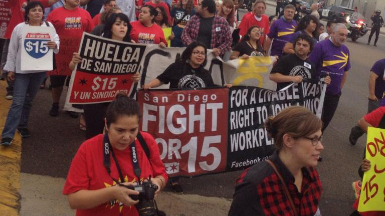 Marchers participate in the fast food strike in City Heights