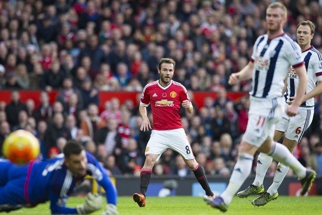 Manchester United's Juan Mata centre attempts to score past West Bromwich Albion's goalkeeeper Boaz Myhill left during the English Premier League soccer match between Manchester United and West Bromwich Albion at Old Trafford Stadium Manchester Engl