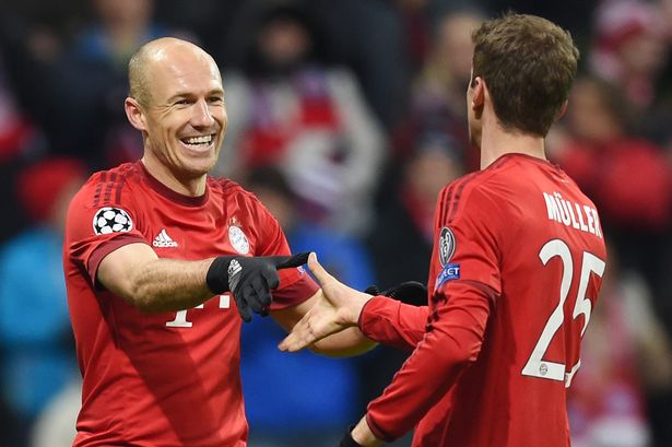 Arjen Robben congratulates goalscorer Thomas Mueller after he scored Bayern Munich's third goal against Olympiacos