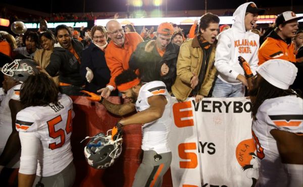 Oklahoma State fans celebrate with the Oklahoma State