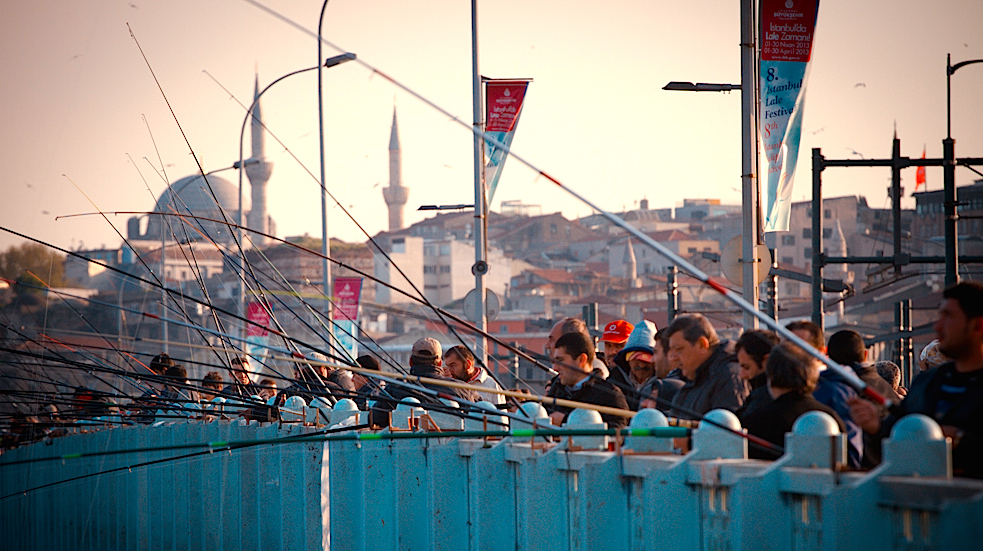 Men fishing on Istanbul bridge to European mainland