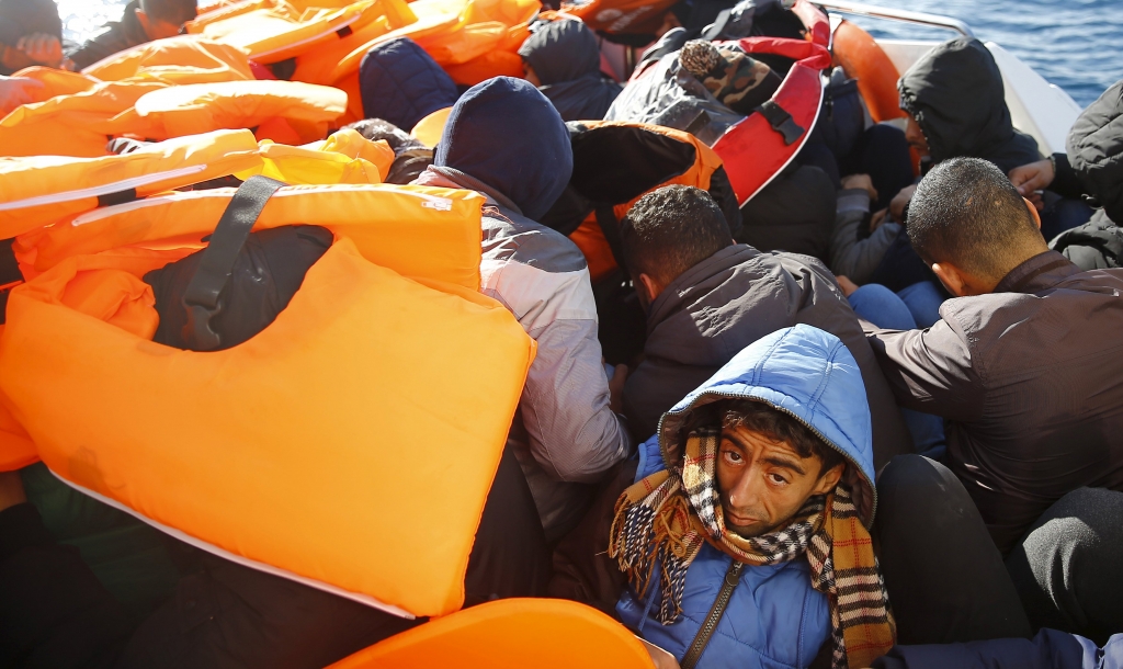 Refugees and migrants sit on board of a Turkish Coast Guard boat off the shores of Canakkale Turkey after a failed attempt of crossing to the Greek island of Lesbos