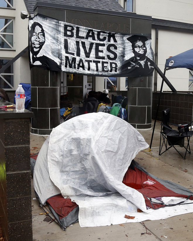 Members of Black Lives Matter continue their encampment Tuesday Nov. 17 2015 outside the Minneapolis Police Department's Fourth Precinct. More than 50 people were arrested during the second day of protests over the shooting of Jamar Clark by a police