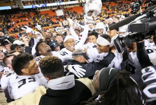 Missouri head coach Gary Pinkel center wipes his