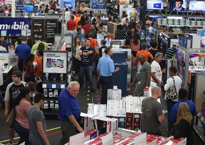 People look at merchandise while holiday shopping at Best Buy on Nov. 26 2015 in Panama City Florida. Early numbers aren’t out yet on how many shoppers headed to stores on Thanksgiving but it’s expected that more than three times the number of