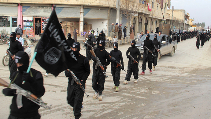 This undated file image posted on a militant website Jan. 14 2014 shows fighters from the al Qaeda-linked Islamic State marching in Raqqa Syria