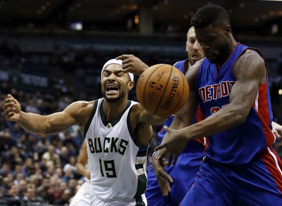 Bayless is fouled as he tries to drive past Detroit Pistons Steve Blake and Reggie Bullock during the second half of an NBA basketball game Monday Nov. 23 2015 in Milwaukee