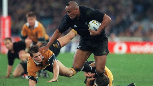 Move Jonah Lomu brushes aside Wallabies Matt Burke and Tiaan Strauss during a Bledisloe Cup Test