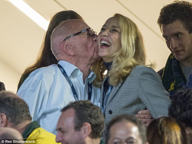 Mr Murdoch moves in for a cheeky kiss much to the amusing of his new girlfriend Jerry Hall