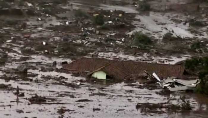 Mud rises up to near the top of the roof of a house in Brazil after a dam break