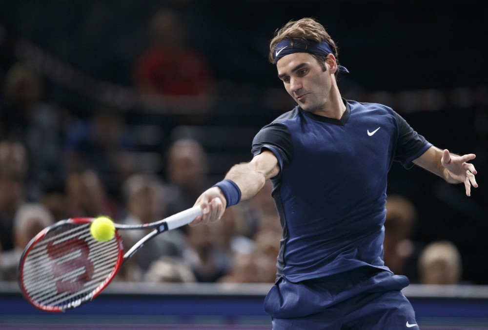 Switzerland's Roger Federer returns the ball to Italy's Andreas Seppi during their second round match of the BNP Masters tennis tournament at the Paris Bercy Arena in Paris France Wednesday Nov. 4 2015. Federer won 6-1 6-1